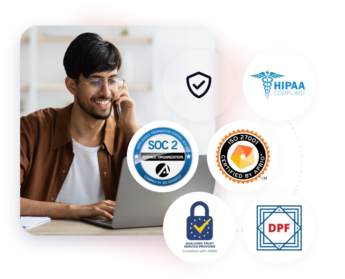 Man looking at laptop while talking on the phone, with security an compliance icons 